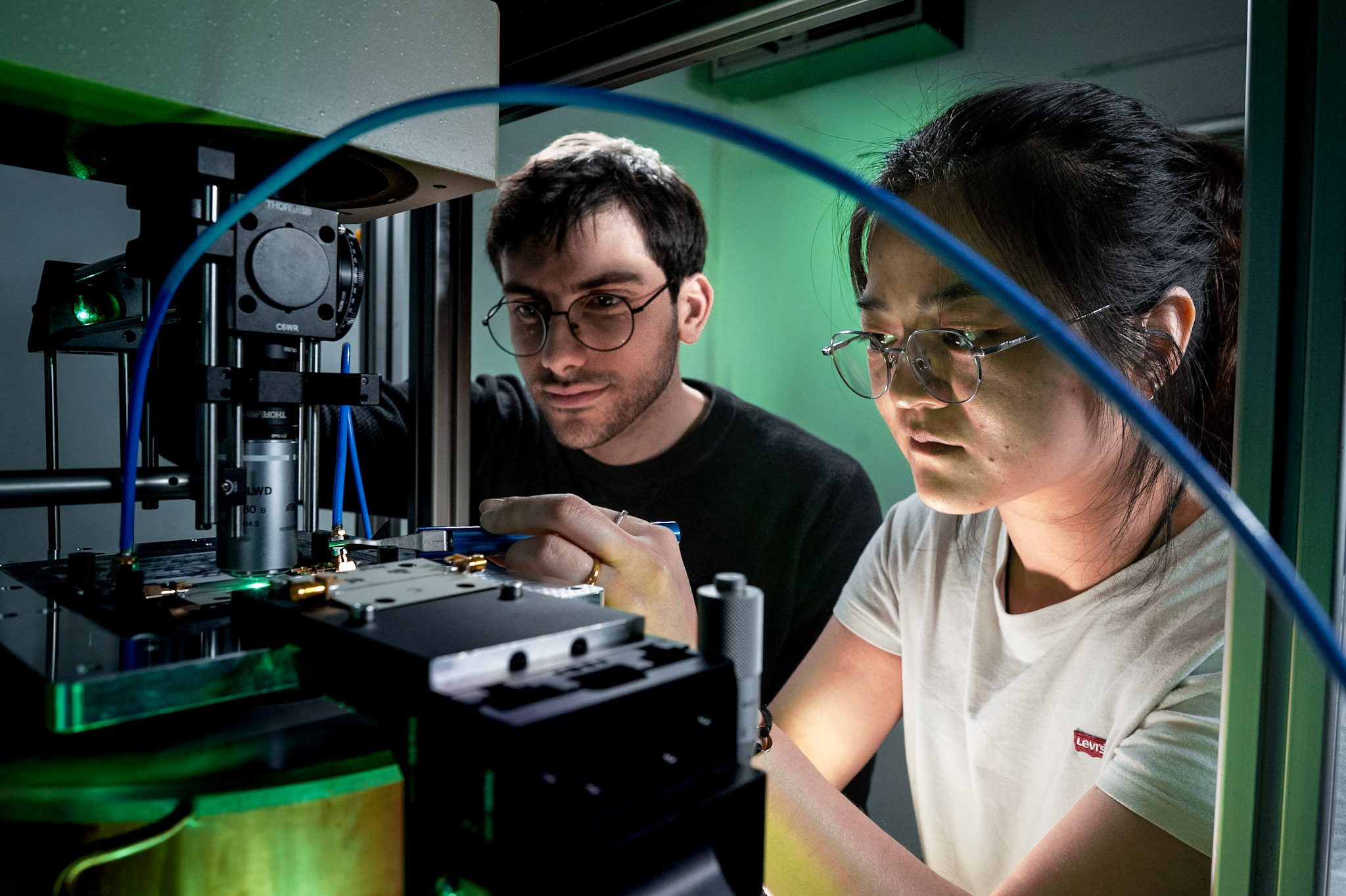 Researchers working at the optical setup in the lab